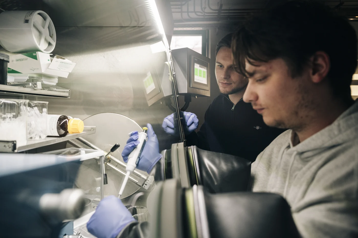 Gemeinsame Arbeit an einer Glovebox im Labor.
